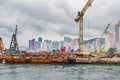 Construction site in the Victoria Harbour against cloudy sky. Building artificial islands in Hong Kong