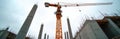 Construction site view with crane, concrete structures. Building under construction. Tall columns with sky. Crane lifts heavy Royalty Free Stock Photo