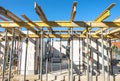 House building: Shell of a new house with ceiling supports at a site and blue sky Royalty Free Stock Photo