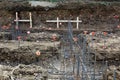 Construction site view of steel rebar foundation framework with orange caps