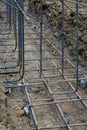 Construction site view of supported grid of steel rebar reinforcement