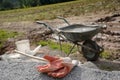 Construction site with wheelbarrow and gloves in background Royalty Free Stock Photo