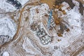 Construction site in winter time with working crane and machinery. aerial top view Royalty Free Stock Photo