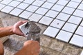 Construction site worker glued ceramic tile floor Royalty Free Stock Photo