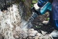 construction site with worker using pneumatic jackhammer for demolishing a structural wall Royalty Free Stock Photo