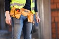 Construction site worker wearing belt with tools Royalty Free Stock Photo