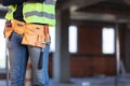 Construction site worker wearing belt with tools Royalty Free Stock Photo