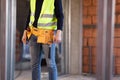 Construction site worker wearing velt with tools Royalty Free Stock Photo