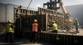 Construction Site Workers in Action Building Concrete Forms with Heavy Machinery on a Cloudy Day. Architectural and Engineering Royalty Free Stock Photo