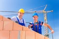 Construction site workers building house with crane Royalty Free Stock Photo