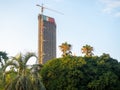 Construction of a skyscraper near the park. House above the trees. Crane next to a tall building Royalty Free Stock Photo