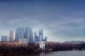 Construction of skyscrapers and high-rise buildings against a cloudy sky. The boom of a tower crane in bad weather with the Moscow Royalty Free Stock Photo