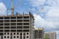 Construction of solid-brick houses, tower cranes on a background Royalty Free Stock Photo