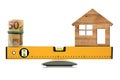 Construction Spirit Level with Roll of Euro Banknotes and a Model House Royalty Free Stock Photo