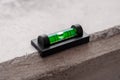 Construction spirit level tool with green bubble on a concrete Royalty Free Stock Photo