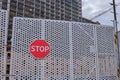 Construction stopped due to coronavirus and quarantine epidemic. Gates with a stop sign on the construction site