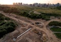 Construction of stormwater pits and sanitary sewer system. Laying of underground storm sewer pipes and sewerage wells.