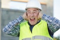 construction suffering from noise pollution on building site Royalty Free Stock Photo