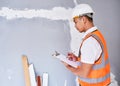 A construction supervisor checks renovation project with checklist on clipboard Royalty Free Stock Photo