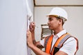 A construction supervisor checks renovation project with checklist on clipboard Royalty Free Stock Photo