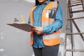 A construction supervisor checks renovation project with checklist on clipboard Royalty Free Stock Photo