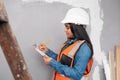 A construction supervisor checks renovation project with checklist on clipboard Royalty Free Stock Photo