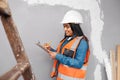 A construction supervisor checks renovation project with checklist on clipboard Royalty Free Stock Photo