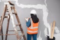 A construction supervisor checks renovation project with checklist on clipboard Royalty Free Stock Photo