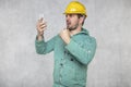 Construction supervisor is shouting to a cell phone, copy space next to him Royalty Free Stock Photo