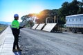 Construction supervisor walking along a new road project during sunrise, symbolizing infrastructure development and future Royalty Free Stock Photo