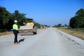 Construction supervisor walking along a new road project during sunrise, symbolizing infrastructure development and future Royalty Free Stock Photo