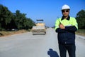 Construction supervisor walking along a new road project during sunrise, symbolizing infrastructure development and future Royalty Free Stock Photo