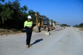 Construction supervisor walking along a new road project during sunrise, symbolizing infrastructure development and future Royalty Free Stock Photo