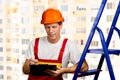 Construction supervisor writes on clipboard. Royalty Free Stock Photo