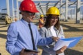 Construction Supervisor And Young Female Architect Checking Project Documents At Construction Site Royalty Free Stock Photo