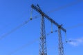 Construction of a support and wires of a high-voltage power line close-up against a blue sky Royalty Free Stock Photo