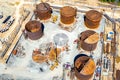 Construction of tank for an oil storage by sheet assembly. View above. Flight around construction site