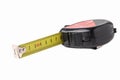 Construction tape measure in black, lying on its side with an open tape. Isolated on a white background. Close up Royalty Free Stock Photo