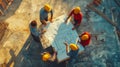 Construction team discussing blueprints on a building site in the afternoon during a project planning meeting Royalty Free Stock Photo