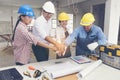 Construction teamwork shaking hands with engineer and foreman in construction site Royalty Free Stock Photo