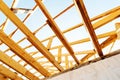 Construction of a timber roof frame. Fragment of a large sawn timber structure. Bottom up view