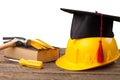 Construction tools and a graduate hat