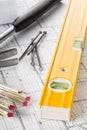 Construction tools with hammer, nails, folding rule and level on architectural blueprint plan Royalty Free Stock Photo