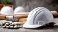 Construction tools including a helmet, gloves, and blueprints are organized on a table at a bustling building site, ready for use Royalty Free Stock Photo