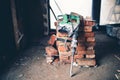 Construction tools, industrial jackhammer with demolition debris and bricks