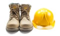 Construction tools leather working boots and yellow helmet isolated on white Royalty Free Stock Photo