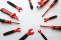 Construction tools in red and black color lie in a circle on a white background, top view-the concept of using the tool in repair Royalty Free Stock Photo