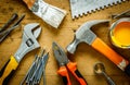 Construction tools on a wooden table with yellow paint Royalty Free Stock Photo