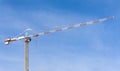 Construction tower crane against blue sky