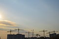 Construction tower crane equipment over building construction site silhouette Royalty Free Stock Photo